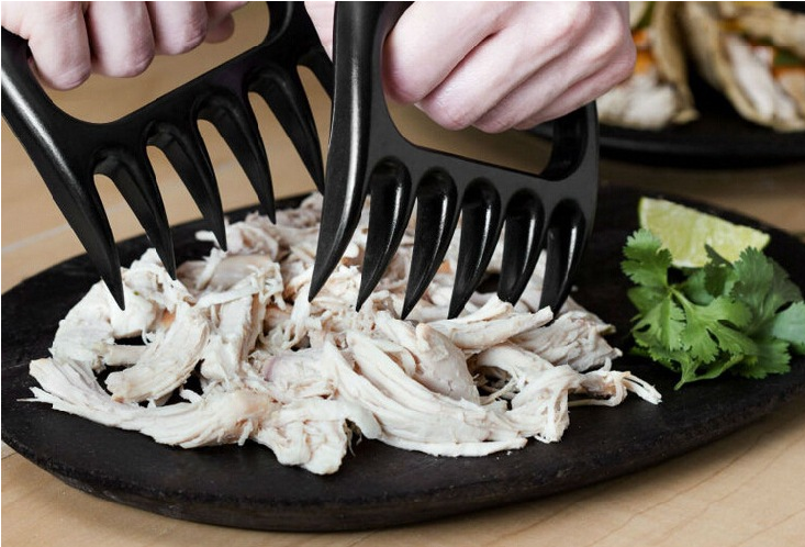 Bear claw shredders pulling cooked chicken
