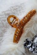 Fashion hair claw clips on a soft neutral background